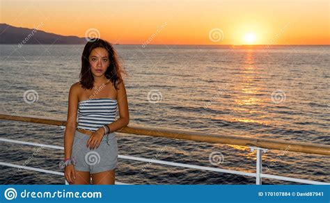 Asian Teen in Tube Top Standing on Deck of Ferry Looking Away from ...