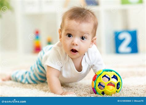 Joyful Baby Crawling on the Floor in Nursery Room Stock Photo - Image ...