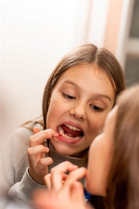Image result for First Loose Tooth Getting Pulled Out