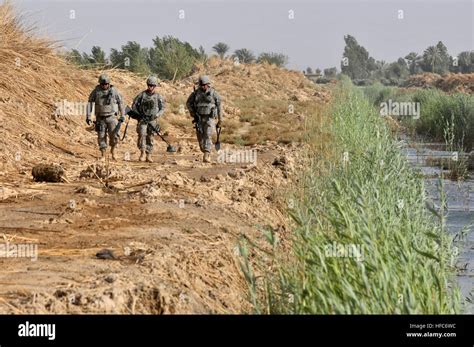 U.S. and Iraqi army soldiers conduct joint weapons cache searches in ...