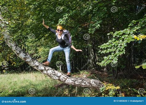 Young Tourist Woman is Holding a Balance on the Birch Branch Stock ...