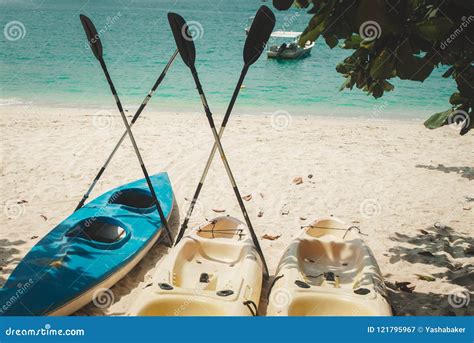 Three Watersport Kayaks with Paddles Drying Out Stock Image - Image of ...