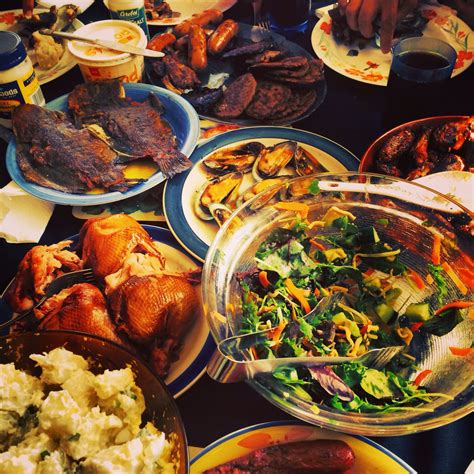 a table filled with plates and bowls full of different types of food ...