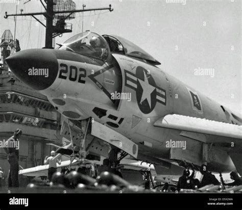 A McDonnell F3H-2M Demon of Fighter Squadron 61 is seen being prepared ...