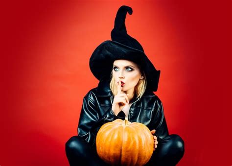 Happy gothic young woman in witch halloween costume secret halloween ...
