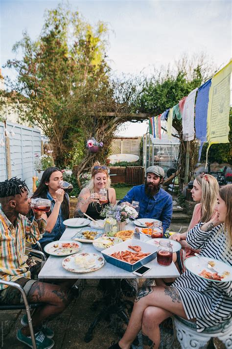 "Group Of Young People Having Lunch And Soft Drinks In A Garden Party ...