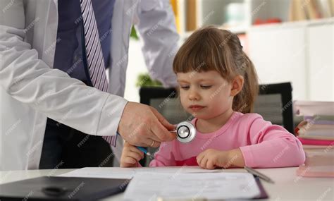 Premium Photo | Hands of pediatrician doctor examining small child with ...