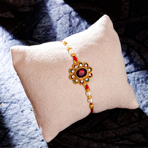 Sukkhi Glorious Gold Plated Floral Meenakari Rakhi with Roli Chawal an