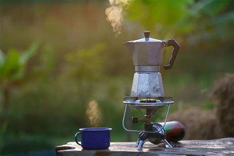 antique coffee Moka pot On the gas stove for camping when the sun rises ...