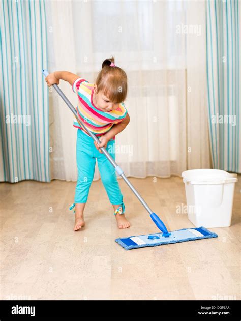 kid girl doing her room cleaning room with mop Stock Photo: 61799874 ...