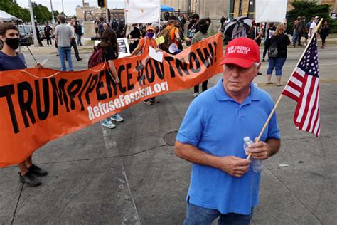 A protester holds a flag during a Black Lives Matter protest in Kenosha ...