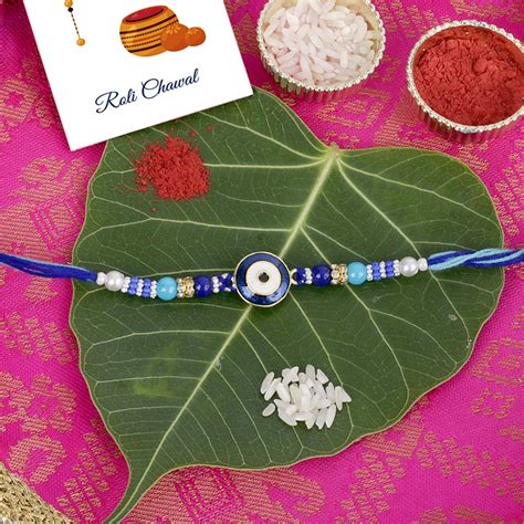 Send Astounding Blue Designer Rakhi with Puja Thali Online ...