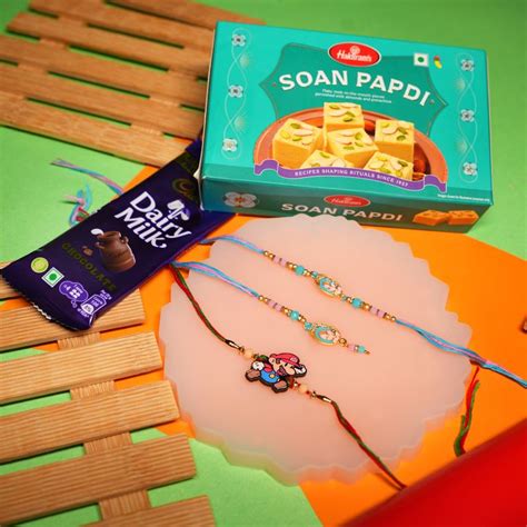 Send Elegant Mario Rakhi with Soan Papdi and Dairy Milk Online