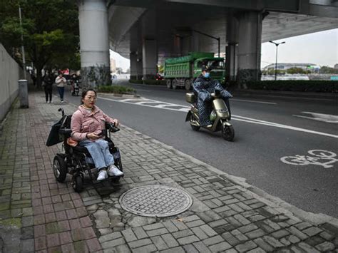 Slow pace of change - China wheelchair users dodge traffic on rough ...