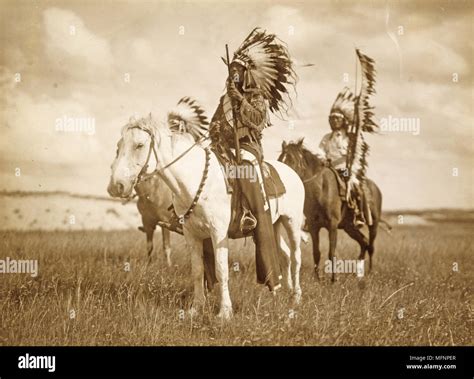 Three Native American chiefs mounted on horses and wearing feather headdresses. Photograph c1890 ...
