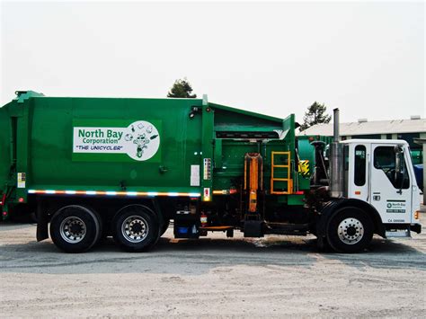 Download A Green Garbage Truck | Wallpapers.com