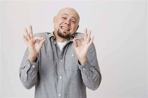 Relaxed bald guy show okay, no problem gesture | Free Photo