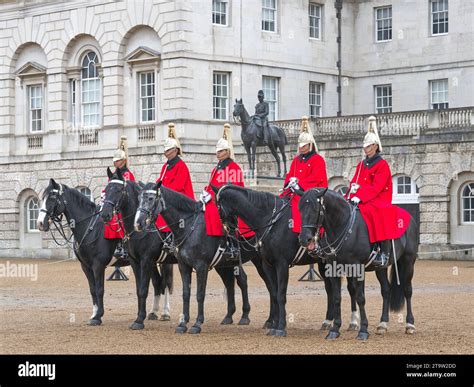Five red coated Lifeguard mounted soldiers line up on Horse Guards ...