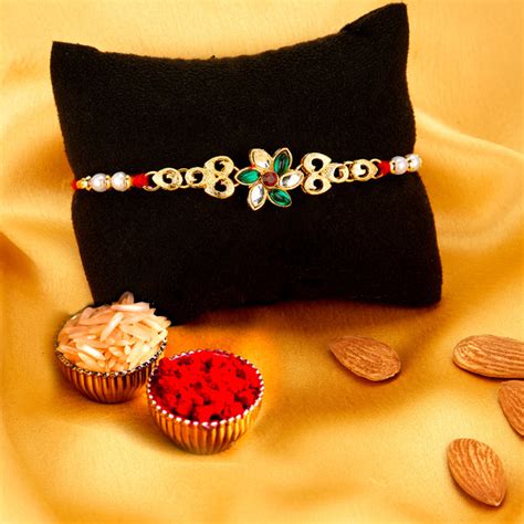 Sukkhi Delicate Gold Plated Floral Rakhi Combo (Set of 2) with Roli Ch ...