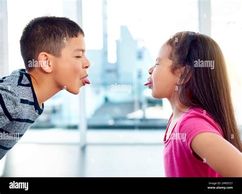 Boy and girl sticking their tongues out hi-res stock photography and ...