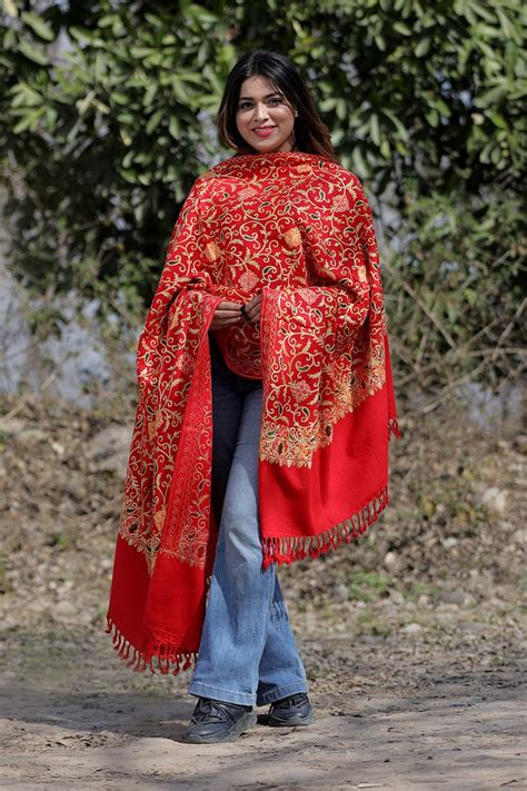 Red color aari work embroidered shawl enriched with running jaal