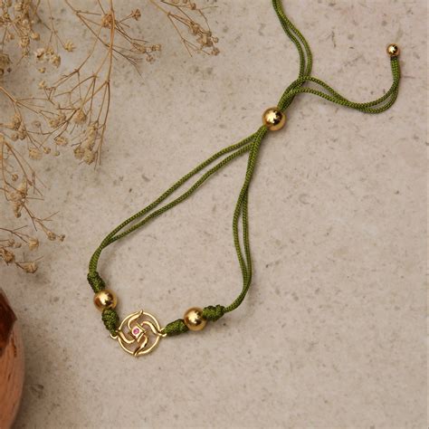Buy Swastik Shakti Gold Plated Silver Rakhi | Tarinika – Tarinika India