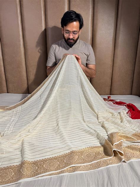 Banarasi georgette silk saree with contarst rich blouse and tassel pal ...