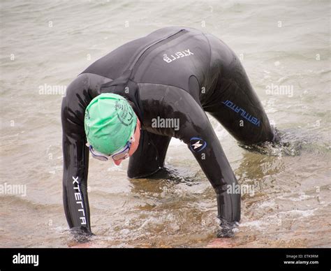 Portsmouth, England 14th June 2014.A competitor crawls from the sea ...