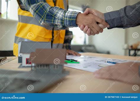 Construction Engineer Joins Hands with Architect To Congratulate Housing Project that Architect ...
