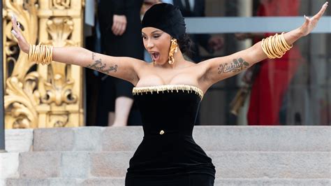 Cardi B throws microphone at fan who threw drink, fan reports battery