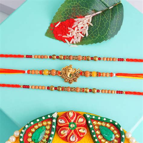 Send Two Beaded Rakhi N One Golden Ganesha Rakhi Online | Rakhibazaar.com