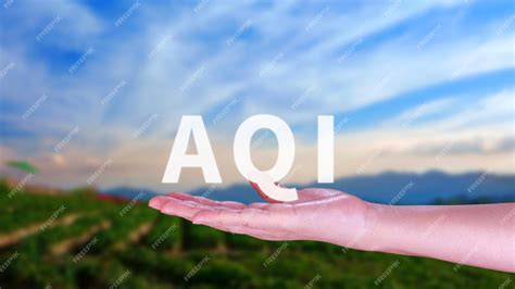 Premium Photo | AQI Abbreviation of air quality index hand holding AQI on nature background ...