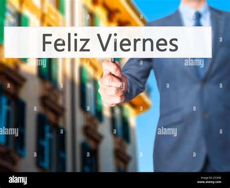 Feliz Viernes (Happy Friday In Spanish) - Businessman hand holding sign ...