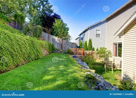 Small Green Fenced Back Yard with Nice Garden. Stock Photo - Image of ...