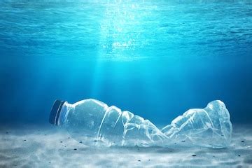 Plastic bottle underwater with sunlight pollution concept | Premium Photo