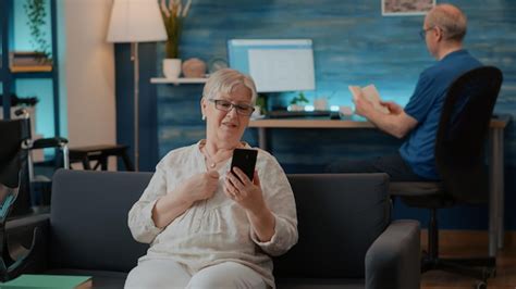 Senior woman chatting on remote video call in living room. old adult ...
