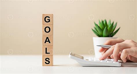 Focused hands calculating financial goals with a calculator on a bright ...