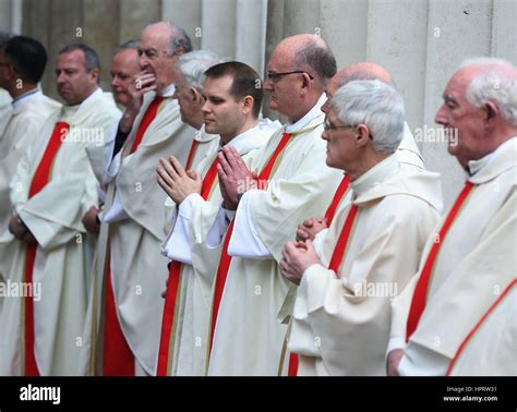 Members of the clergy form a guard of honour following the funeral mass ...