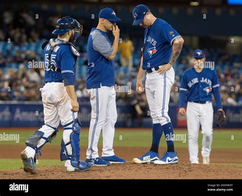 Toronto Blue Jays pitching coach Pete Walker goes out to talk to ...