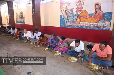 Community kitchen Feature Photo People eat prasad (food...