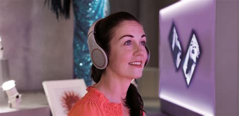 A woman smiles as she engages with the "DIVA" exhibition at the ...