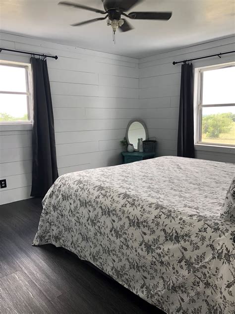 Shiplap Bedroom Wall with Beautiful Black Vinyl Plank Flooring