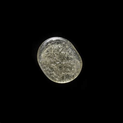 A FATIMID GLASS WEIGHT OF QUARTER DINAR, EGYPT AL-MUSTANSIR BI-ALLAH (AH 427-487 / 1036-1094 AD)