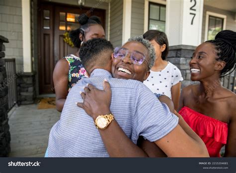 Family Welcoming Hugging Woman Front Porch Stock Photo 2215204681 | Shutterstock