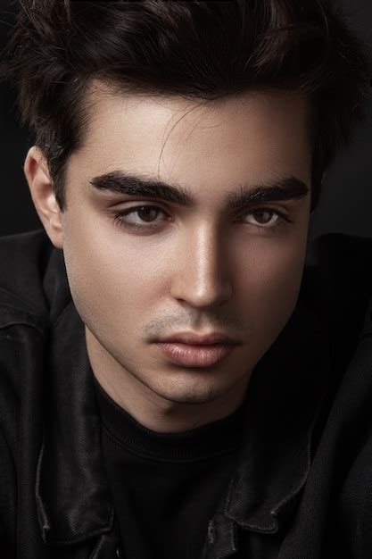 Portrait of a handsome young man, confident. wears black clothes ...