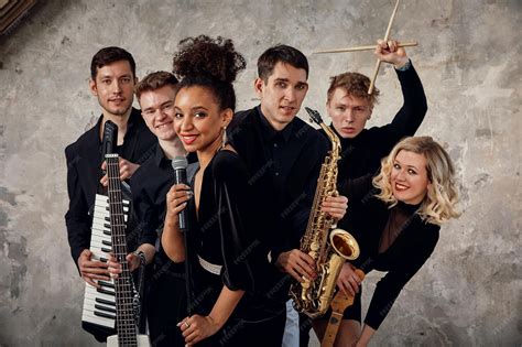 Portrait of diverse group of young people musical band playing with ...