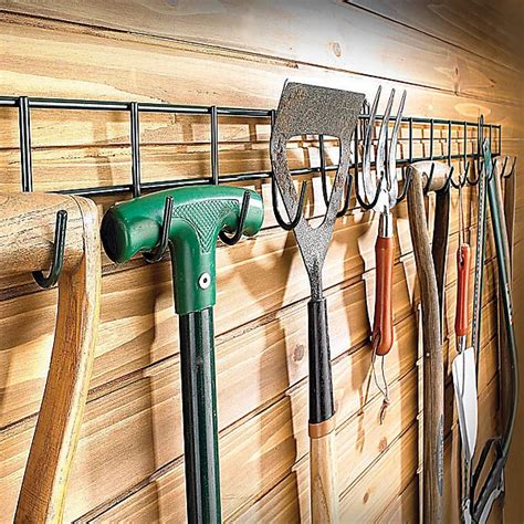https://media.diy.com/is/image/KingfisherDigital/extra-long-tool-rack-wall-mounted-garden-tool-holder-with-16-hooks-for-shed-or-garage-measures-h11-5cm-x-w100cm~30772014_04c_MP?%24MOB_PREV%24=&%24height=600&%24width=600