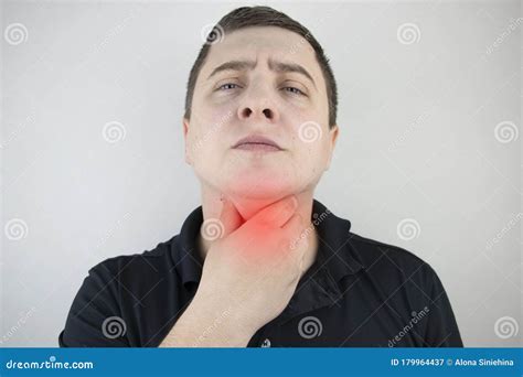 Man Touches a Sore Throat and Neck, Twists from Irritation and Inflammation. Sore Throat when ...