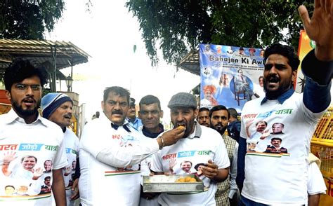 Congress workers offer sweets to each other as they celebrate