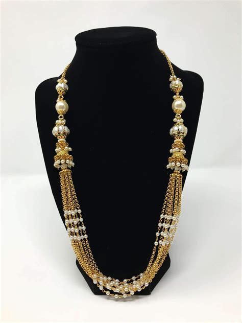This set features multi layer chains of pearls and pearl balls. The set ...